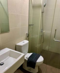 a bathroom with a toilet and a shower and a sink at Atlantis Residence Melaka ForMuslims Homestay in Melaka