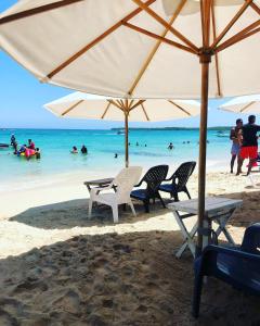 a group of chairs and an umbrella on a beach at baru express in Cartagena de Indias