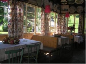 a dining room with two tables and chairs and windows at Gasthof Staudach in Hollenstein an der Ybbs