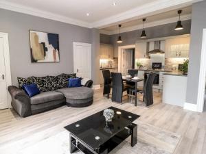 a living room with a couch and a table at St John's North Hotel Apartments in Wakefield
