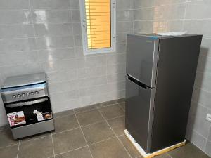 a stainless steel refrigerator and an oven in a kitchen at 1704 Najah Tevragh Zeina in Nouakchott