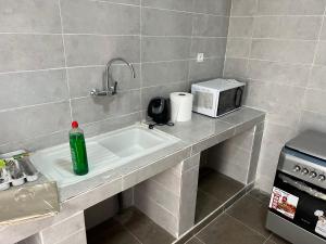 a kitchen counter with a sink and a microwave at 1704 Najah Tevragh Zeina in Nouakchott