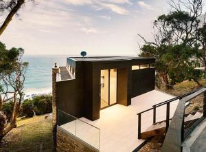 a black house with a view of the ocean at Sea Ranch in Wye River