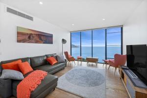 a living room with a couch and a television at Cape Wye in Wye River