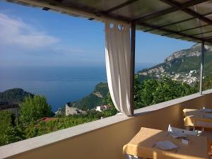 a room with a large window with a view of the ocean at Casa Falcone B&B in Scala