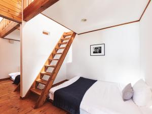 a bedroom with a loft bed and a ladder at &SUN Penthouse in Yokosuka