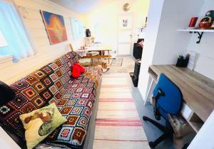 a living room with a couch and a blue chair at Seiland BlueDream HolidayHome in Skakkebakken