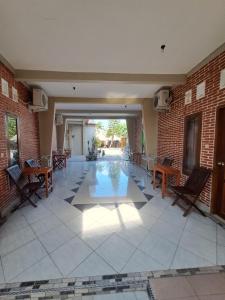 an empty lobby with chairs and a tile floor at Azza karimunjawa in Karimunjawa
