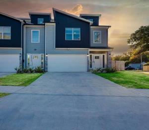 a large house with a driveway in front of it at NEW Classic Cozy Gem *Med/NRG* in Houston