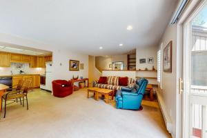 a living room with a couch and a table at Copper Grove in Copper Mountain