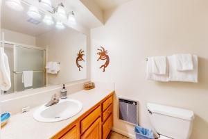a bathroom with a sink and a mirror at Copper Grove in Copper Mountain