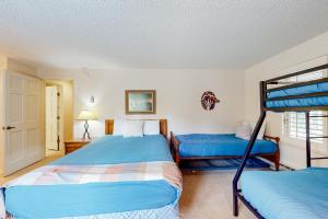 a bedroom with two beds and a bunk bed at Copper Grove in Copper Mountain