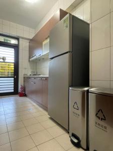 a kitchen with a stainless steel refrigerator at Mountain Beyond Guest House in Jinhu