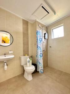 a bathroom with a toilet and a shower and a sink at Casa Ipoh Homestay by Comfort Home in Chemor