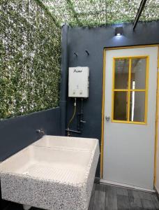 ein Badezimmer mit einer weißen Badewanne neben einer Wand in der Unterkunft Nuevo y Hermoso Departamento Pachuca in Mineral de la Reforma