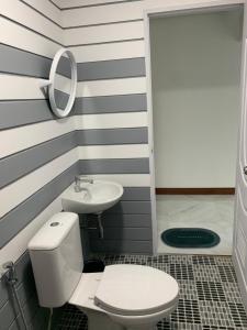 a bathroom with a toilet and a sink at Mook tawan Beach house in Koh Mook