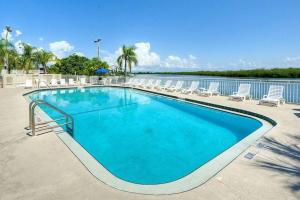 a large blue swimming pool with chairs and water at Little Harbor Resort #109 Tampa Bay FL Beach, 2 Pools, Riverview in Ruskin