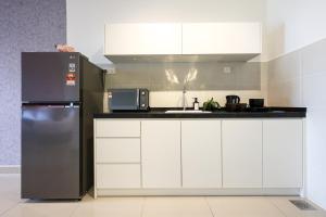 a kitchen with a refrigerator and a sink at Bali Residences @ Icon Stay Melaka in Melaka
