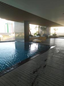 a swimming pool in the middle of a building at DeAr Caspian Apartment in Surabaya