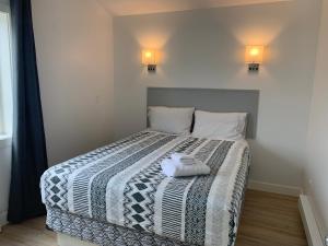 a bedroom with a bed with two towels on it at Destination Inn Cache Creek in Cache Creek