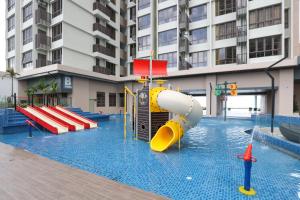 a pool with a water slide in a building at Bali Residences @ Icon Stay Melaka in Melaka