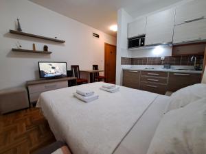 a kitchen with a white table in a room at Zlatiborski konaci k17 i K19 in Zlatibor +23 photos
