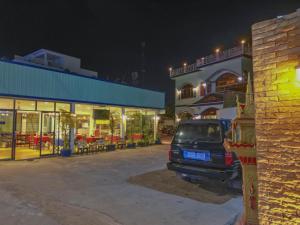 a car parked in a parking lot next to a building at Blossoming Romduol Boutique in Siem Reap