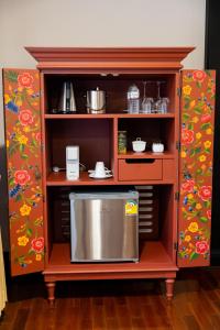 a wooden cabinet with a stainless steel kitchen in it at Lanna Resort Chiang Mai in Ban Dong