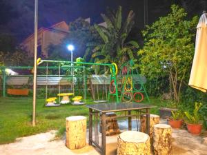 a playground in a yard at night at Blossoming Romduol Boutique in Siem Reap