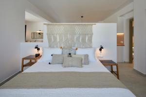 A bed or beds in a room at Santorini Hillside Suites & Villas