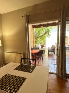 a room with a table and a view of a patio at Le Clos de Canet in Canet d'Aude