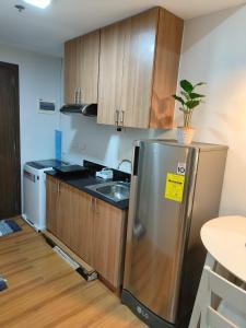 a kitchen with a stainless steel refrigerator and a sink at ZSL Elegant Condo LOOP Tower 1 in Cagayan de Oro