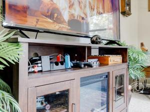 a entertainment center with a tv on top of it at Mid-Century Brick Bungalow Home in Evansville