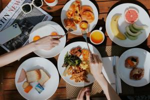 a table with plates of food on it at The Westin Tashee Resort, Taoyuan in Daxi