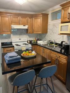 a kitchen with a table with a bowl of fruit on it at Private suite 1 bed 1 bath 15 mins YVR and downtown 舒适安静 in Vancouver