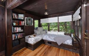 a bedroom with a bed and a book shelf at On the River in Gatlinburg