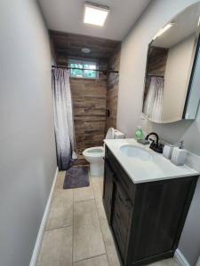 a bathroom with a sink and a toilet at Vast Stylish Apt Close to NYC! in North Bergen