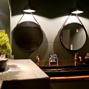 a bathroom with two mirrors above a sink at Le Domaine de la Roche Bernard Jacuzzi, piscine & Sauna 