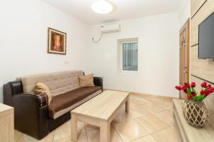 a living room with a couch and a coffee table at Apartment Hotel Prego in Ulcinj