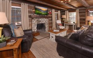 a living room with a couch and a fireplace at On River Time in Gatlinburg