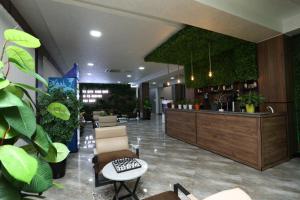 a lobby with a bar and some plants at CHlNOR HOTEL in Andijan