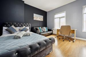a bedroom with a bed and a desk and a chair at Mega Flat Near Arndale City Centre in Manchester