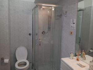 a bathroom with a shower with a toilet and a sink at My Sweet Rooms in Rome