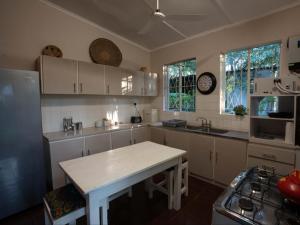 a kitchen with white cabinets and a white counter top at The Art House Victoria Falls in Victoria Falls