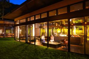 two people sitting on a porch of a building at night at TAOYA Nasu Shiobara in Nasushiobara +13 photos