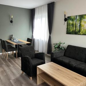 a living room with a couch and a table at Breitbacher Hof in Waldbreitbach