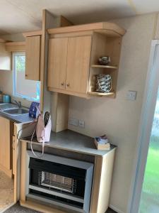 a small kitchen with a stove and a sink at Kingsgate 49 in Shanklin