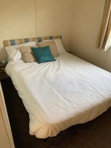 a large white bed with two pillows on it at Kingsgate 49 in Shanklin