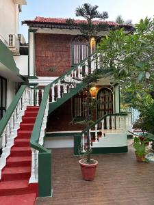 a building with a staircase leading to a house at Olive Calangute Mira - by Embassy Group in Calangute