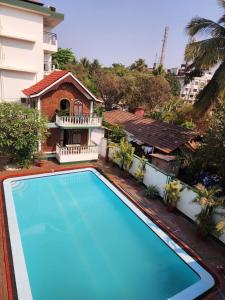 an empty swimming pool in front of a building at Olive Calangute Mira - by Embassy Group in Calangute